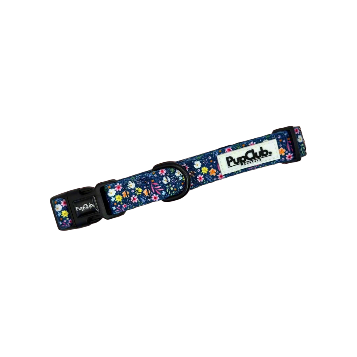 Deep blue dog collar with a small pink, white and yellow flower print, black side-release buckle and black D ring