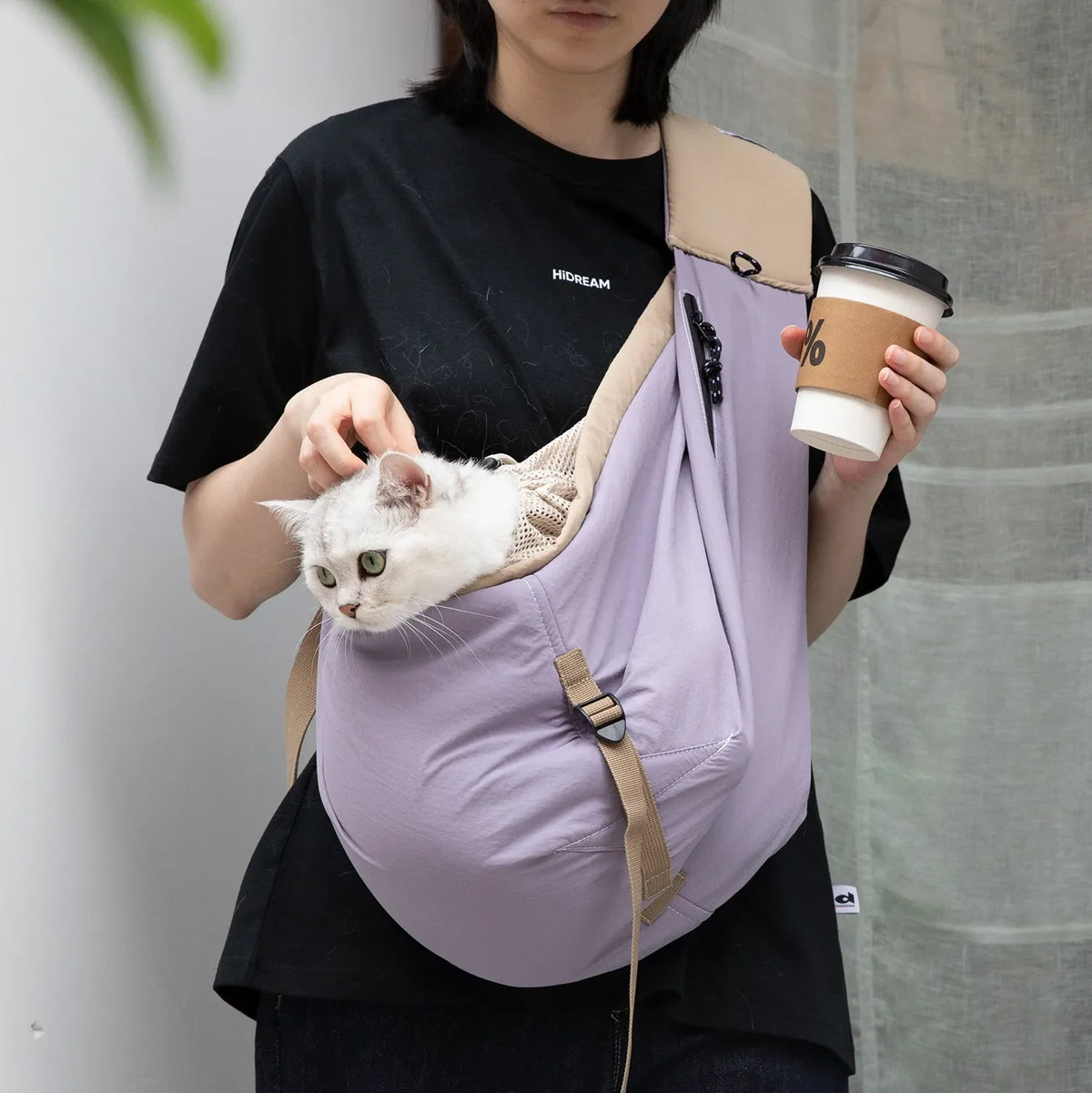 Beige and olive green crossbody pet sling carriers with padded shoulder straps, zip side pockets and adjustable straps